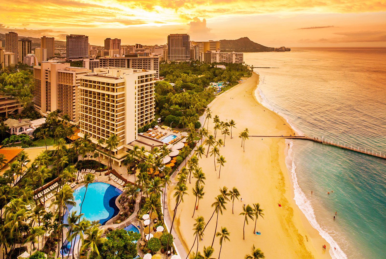 Ali'i Tower at sunrise with a golden cast from the sunrising over Diamond Head