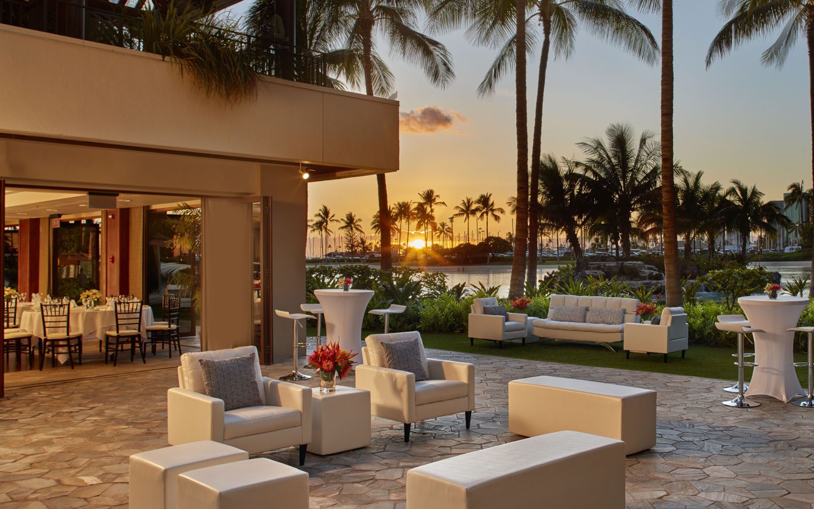 Rainbow Suite outdoor patio for events. The sun is setting in the background.