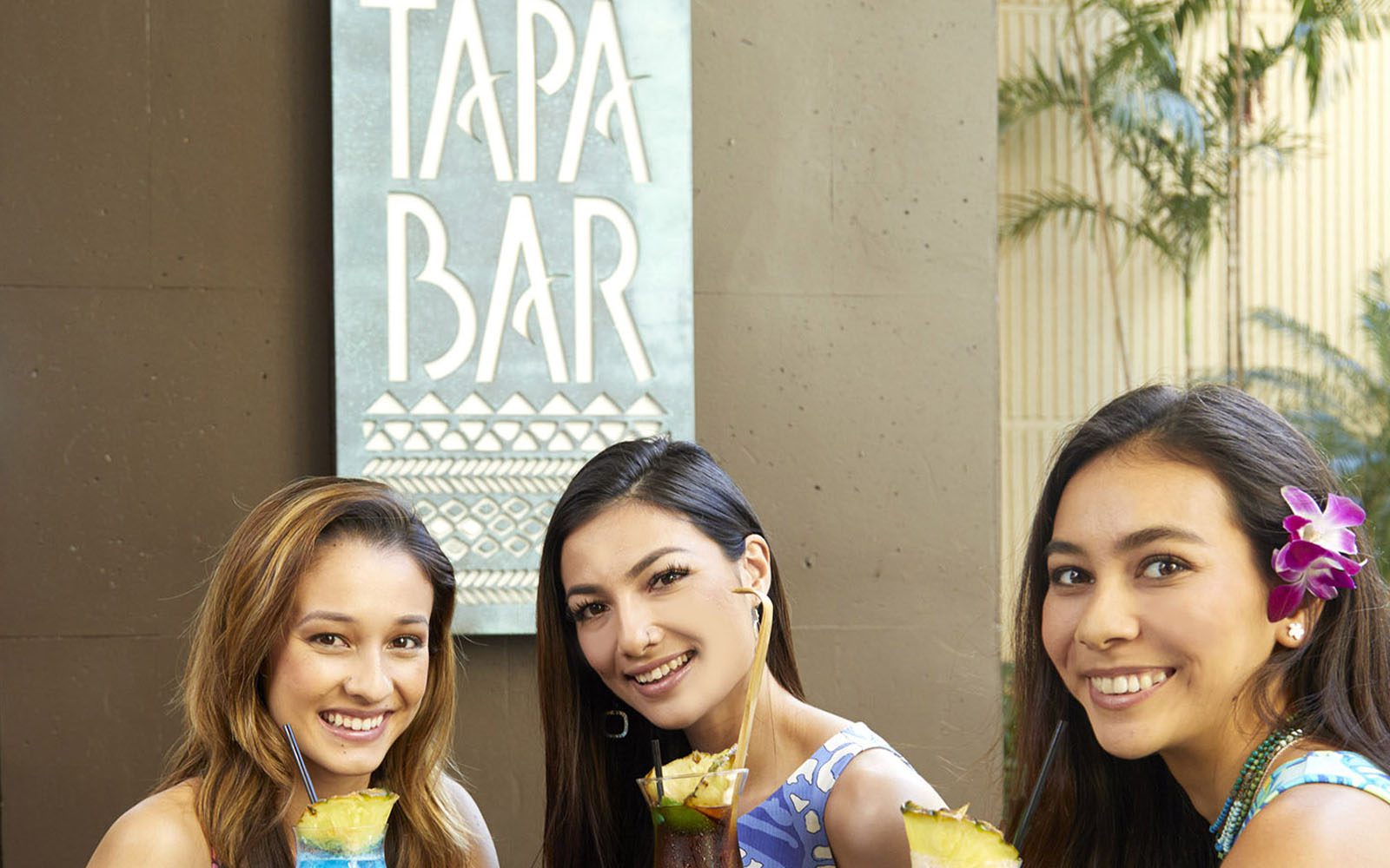 Three smiling girls at the Tapa Bar