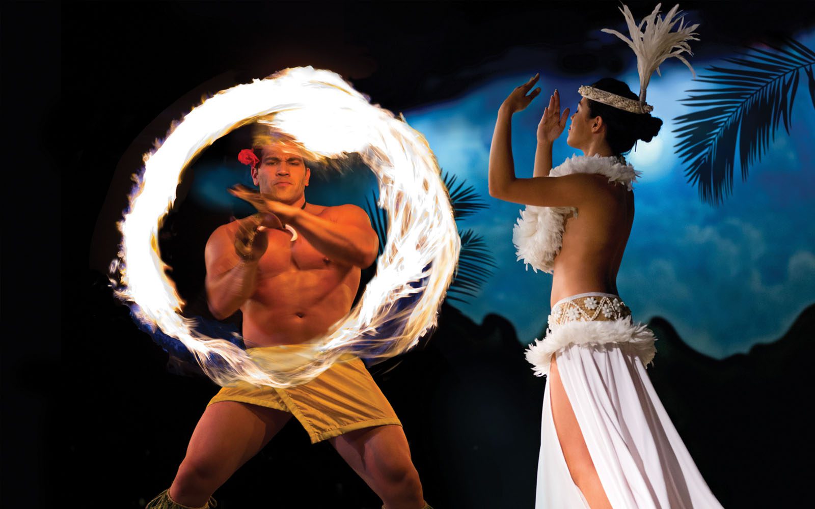 Waikiki Starlight Luau fire dancer and hula dancer and a award call out on being one of the 10 best luaus in Hawaii