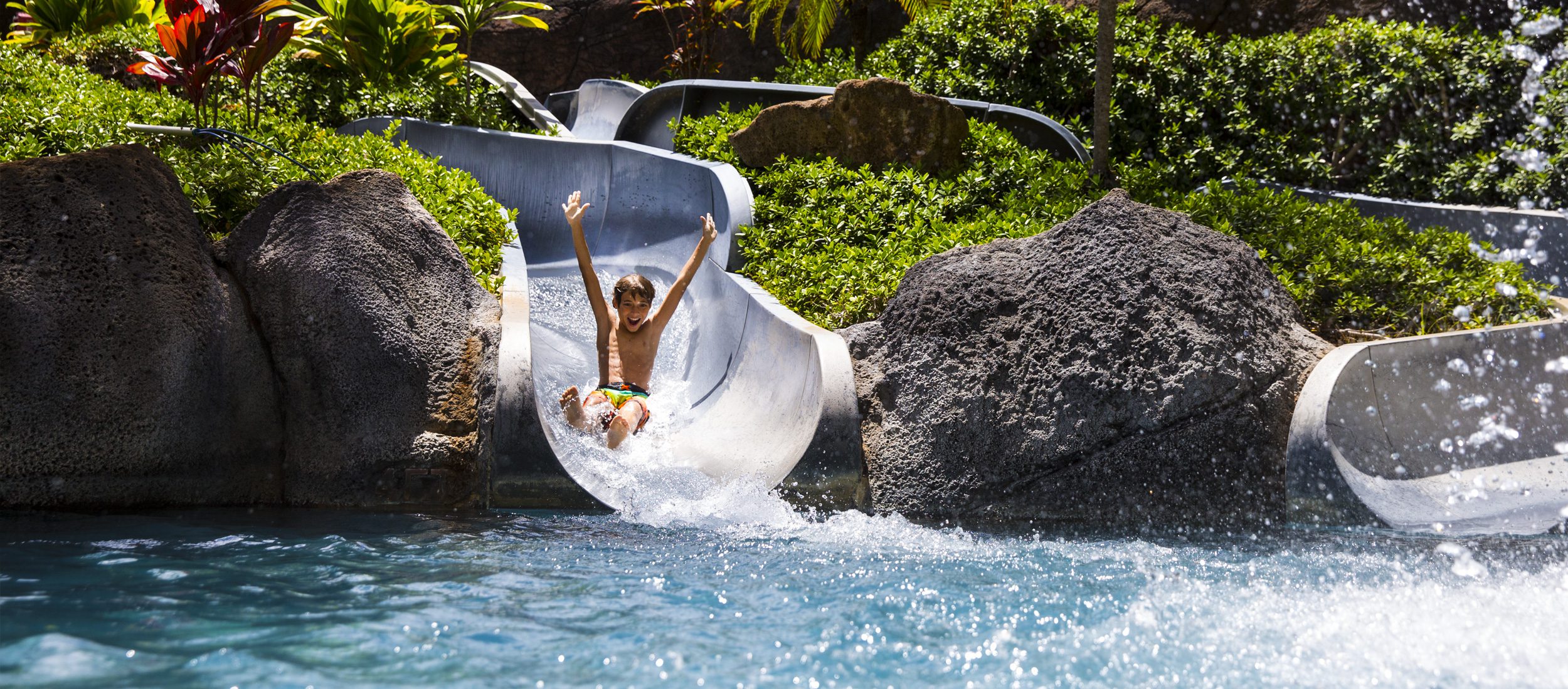 A child on a waterslide at the Hilton Hawaiian Village