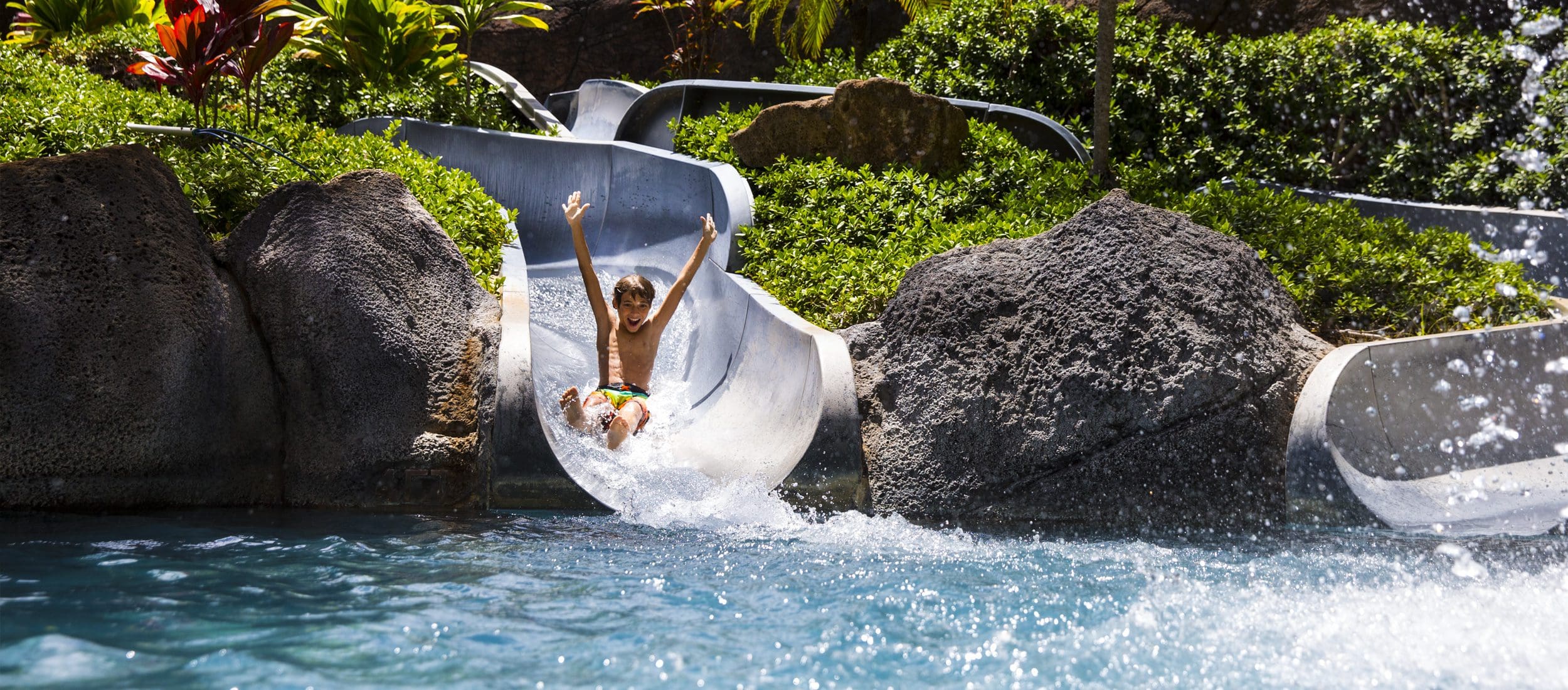 A child on a waterslide at the Hilton Hawaiian Village