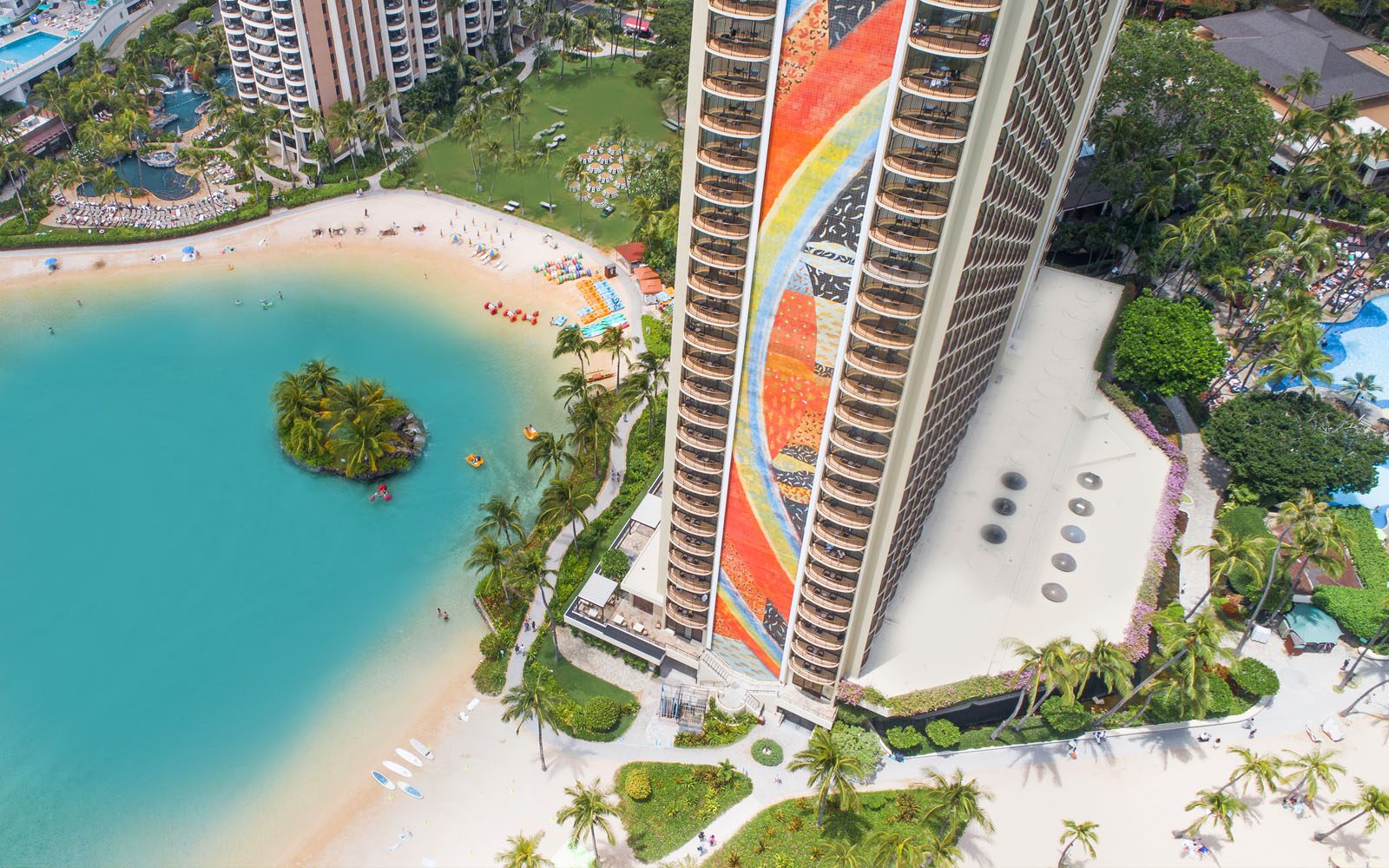Aerial photograph of Duke Kahanamoku lagoon on the left and Rainbow Tower at center