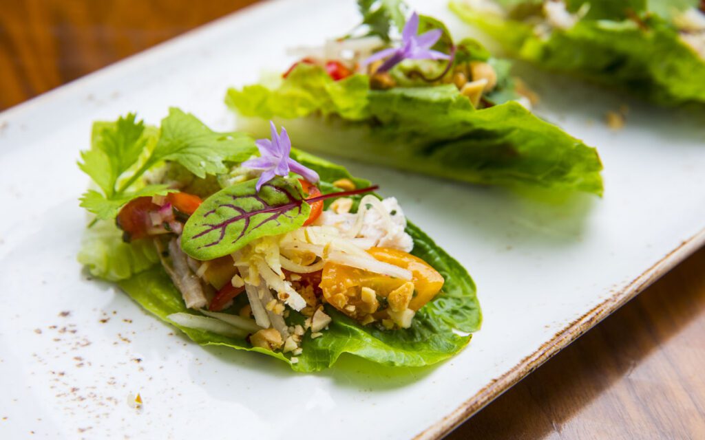 Lettuce leaf with vegetables and garnish.