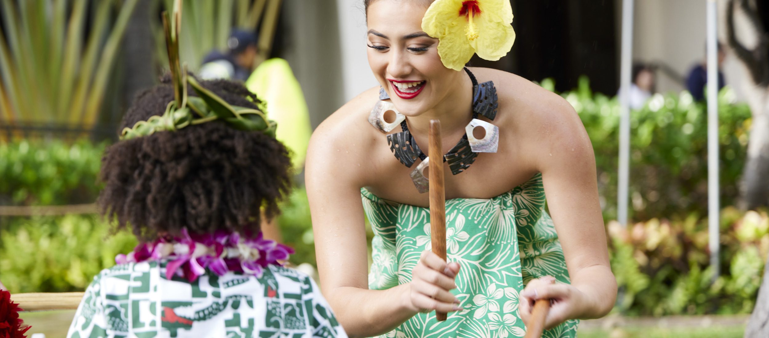 Playing percussive instruments at the Waikiki Starlight Luau