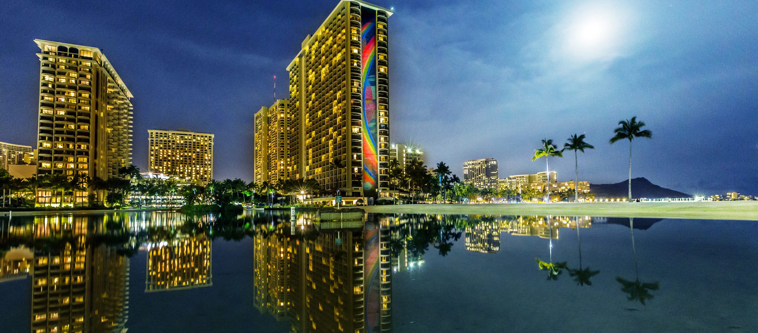 Hilton Hawaiian Village in the evening with Rainbow Tower by moonlight