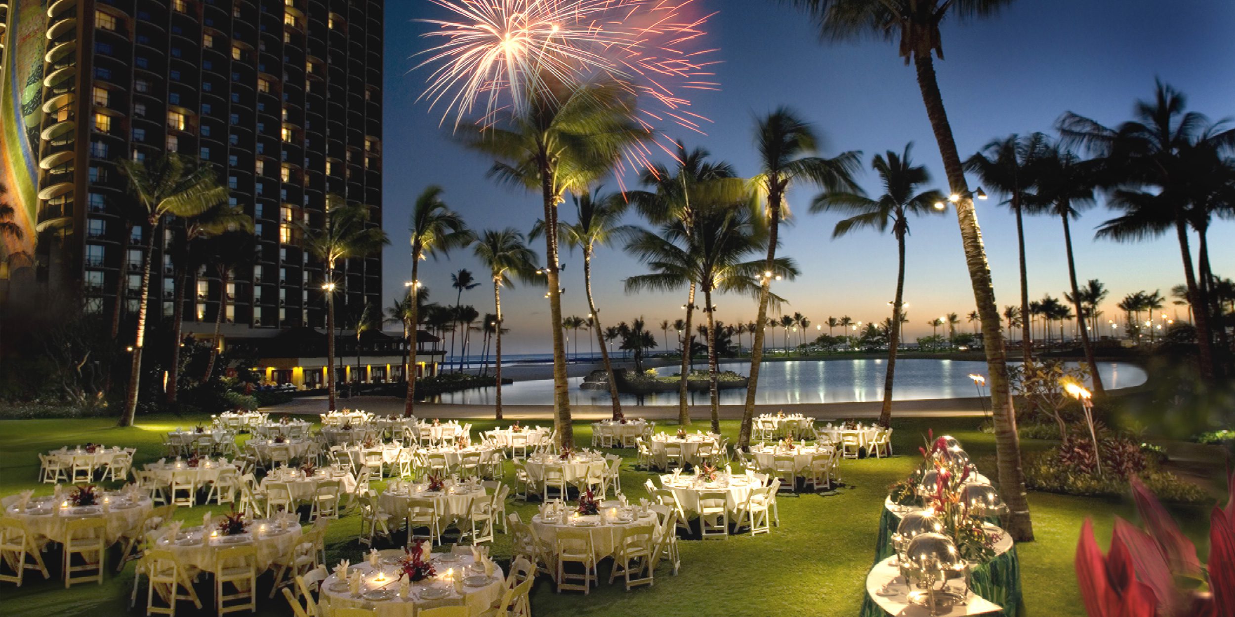 A photo of fireworks above the Great Lawn at Hilton Hawaiian Village